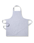 The Petite Plumes Adult Apron in Navy French Ticking features thin vertical blue and white stripes. Ideal for holiday baking, it has neck and waist straps with a diagonal flair, keeping you stylishly protected in the kitchen.