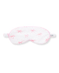 The Adult Pima Sleep Mask in Blushing Bows features a white design with pink bows, pink trim, an elastic strap, and a side tag that reads "PETITE.