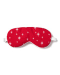 The Adults Flannel Sleep Mask in Starry Night by Petite Plume, featuring white stars on red and an adjustable strap, makes a perfect gift. Pair it with matching eye masks for added thoughtfulness.