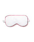 The Petite Plume Adults Twill Sleep Mask in White with Red Piping, elegantly displayed on a white background, features an elastic strap. Its perfect for those looking for matching eye masks or a special monogrammed gift.