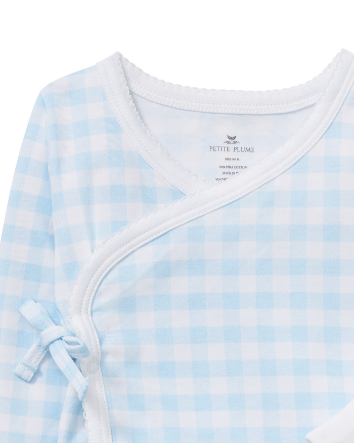 Close-up of the Baby Pima Wrap Set in Light Blue Gingham, featuring a light blue and white gingham pattern with white trim and a small side bow.