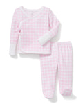 The Baby Pima Wrap Set in Pink Gingham features a pink and white checkered long-sleeve pajama top with a front side tie, white cuffs, and matching footed pants.