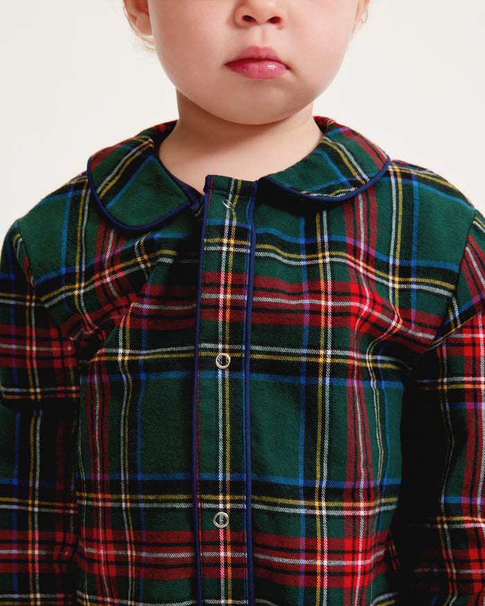 The Baby's Brushed Twill Cambridge Romper in Kensington Tartan features long sleeves, full length, a green, red, and blue plaid design, front zipper, leg snap buttons, and a rounded collar.