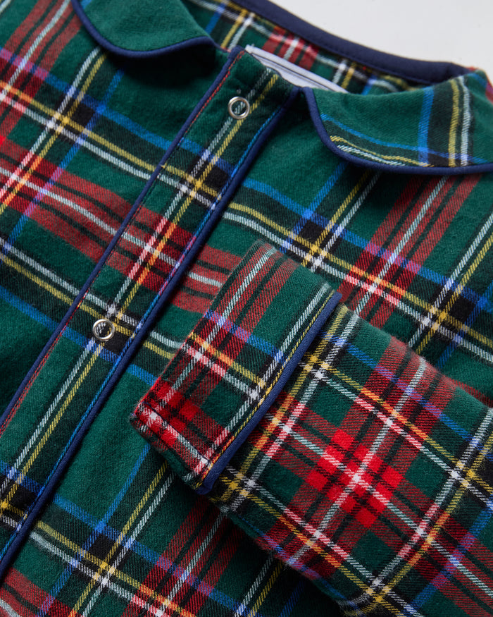 The Baby's Brushed Twill Cambridge Romper in Kensington Tartan features long sleeves, full length, a green, red, and blue plaid design, front zipper, leg snap buttons, and a rounded collar.