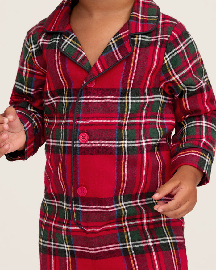 The Baby's Brushed Twill Classic Romper in Imperial Tartan features long sleeves, a collar, button front, and snap leg closures for easy diaper changes. Showcased on a white background, it has a red base with green, white, and yellow stripes.