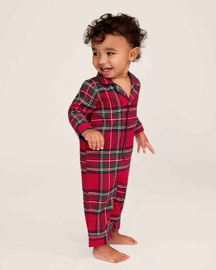 The Baby's Brushed Twill Classic Romper in Imperial Tartan features long sleeves, a collar, button front, and snap leg closures for easy diaper changes. Showcased on a white background, it has a red base with green, white, and yellow stripes.