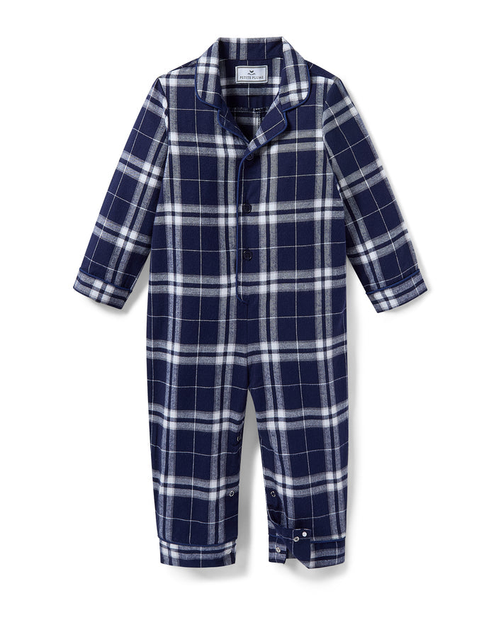 The Baby's Brushed Twill Classic Romper in Oxford Tartan is a full-length, long-sleeve children's onesie featuring a navy, white, and gray plaid pattern with a button-up front, collar, and snap leg closures.