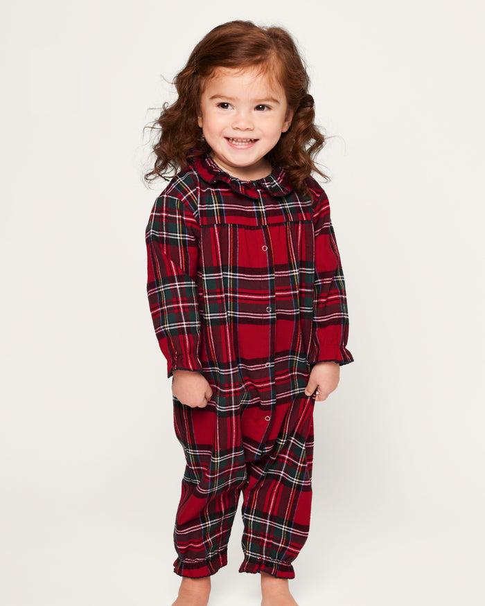 The Baby's Brushed Twill Madeline Romper in Imperial Tartan features long sleeves, a ruffled collar, snap buttons down the front, and gathered cuffs, all in a festive red, green, and white plaid.