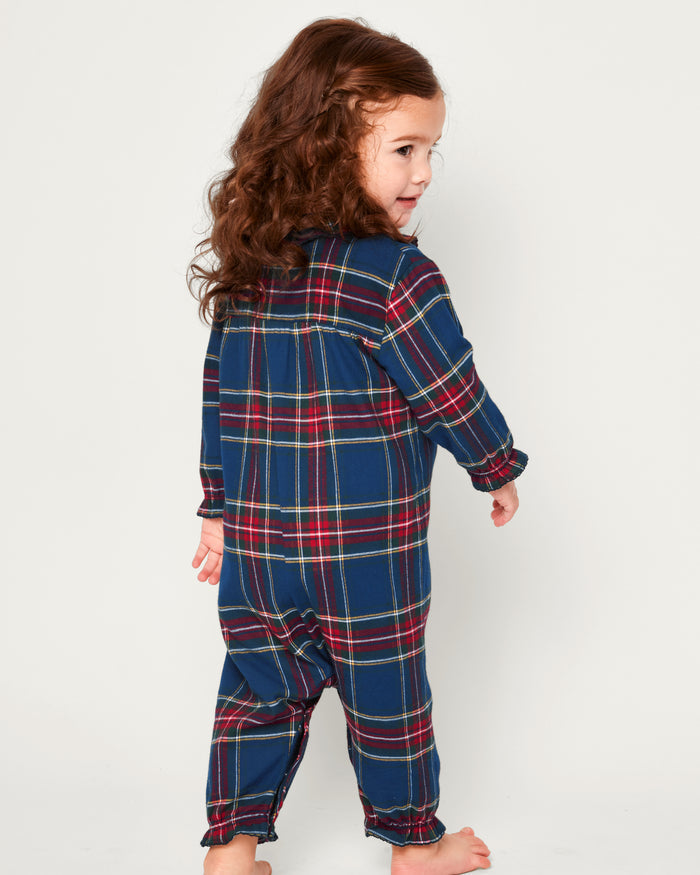 Close-up of the Babys Brushed Cotton Madeline Romper in Windsor Tartan by Petite Plume, featuring a plaid design with red, green, and blue colors, a ruffled collar, and snap buttons. The label ensures it is chemical-free for comfort and peace of mind.