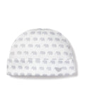 The Babys Pima Hat in Grey Elephants by Petite Plume, made from soft Peruvian Pima Cotton, showcases light gray elephants and a small embroidered emblem on the folded brim, providing a charming and comfortable finish to any baby outfit.