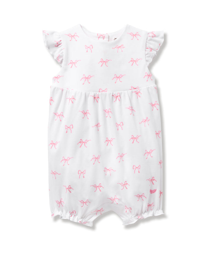 Discover the Petite Plume Babys Pima Isla Play Romper in Blushing Bows. Made from 100% Pima cotton, this white romper features charming pink bow patterns, ruffled short sleeves, and elasticized leg openings for comfort and style.