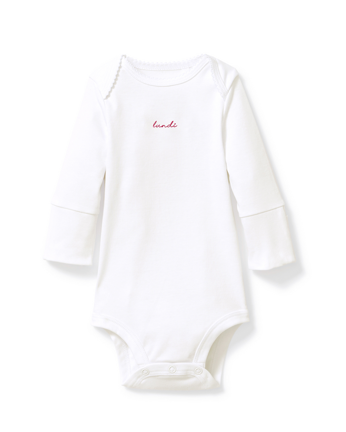 Baby’s Pima Long Sleeve Onesie Set in French Lessons Pink features a white long-sleeved onesie with small red “loved” text on the chest and convenient snap closures at the bottom, displayed against a plain white background.
