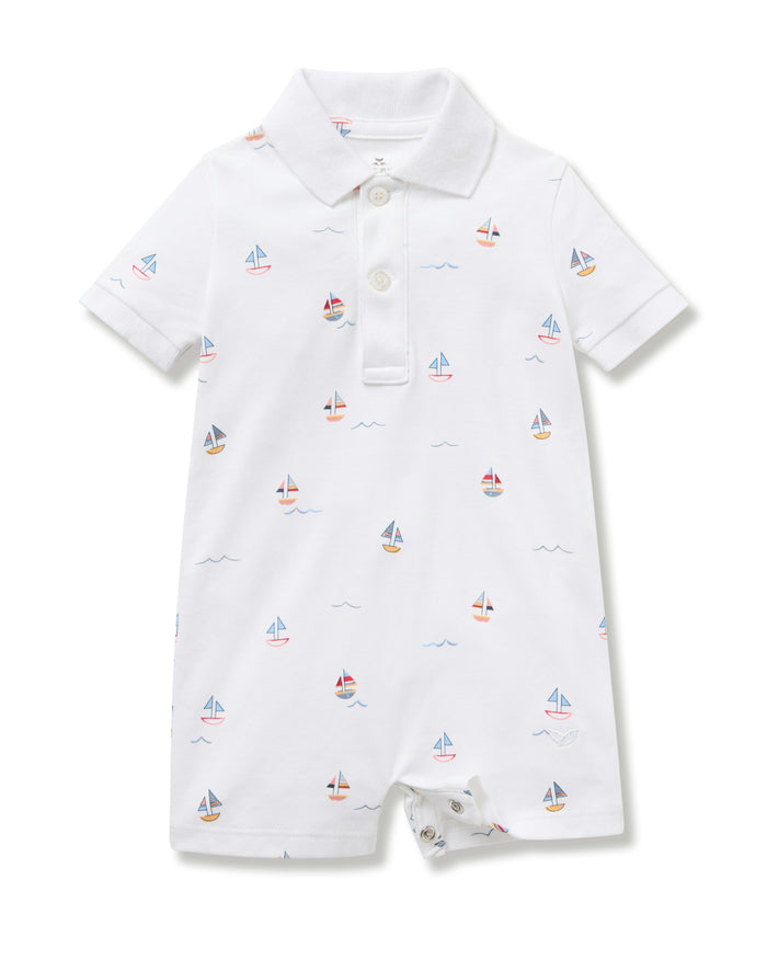 White baby romper with sailboat pattern on a white background