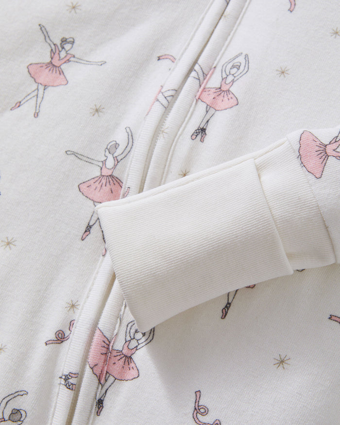 The Baby's Pima Peekaboo Romper in Sugar Plum Fairy is a long-sleeve white onesie featuring a front zipper, pink ballerina and flower prints, plus solid white cuffs and ankles.