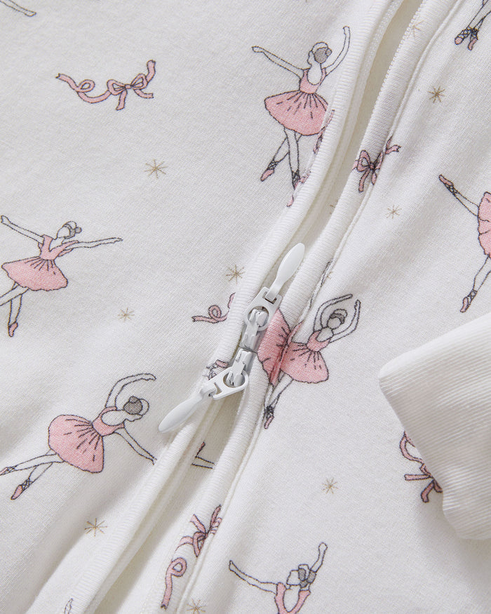 The Baby's Pima Peekaboo Romper in Sugar Plum Fairy is a long-sleeve white onesie featuring a front zipper, pink ballerina and flower prints, plus solid white cuffs and ankles.