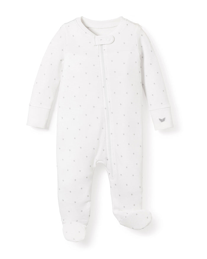 Petite Plumes Babys Pima Romper in Grey Stars features a soft Pima cotton fabric with tiny gray stars, long sleeves, and footed legs. It includes a front snap closure and a small tag logo on the sleeve, all set against a plain white background.