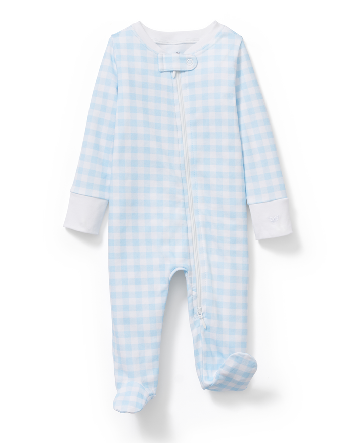 The Baby’s Pima Romper in Light Blue Gingham features a light blue and white gingham pattern, long sleeves with white cuffs, a diagonal zipper from the neck to the left ankle, covered feet, and a snap closure at the collar.