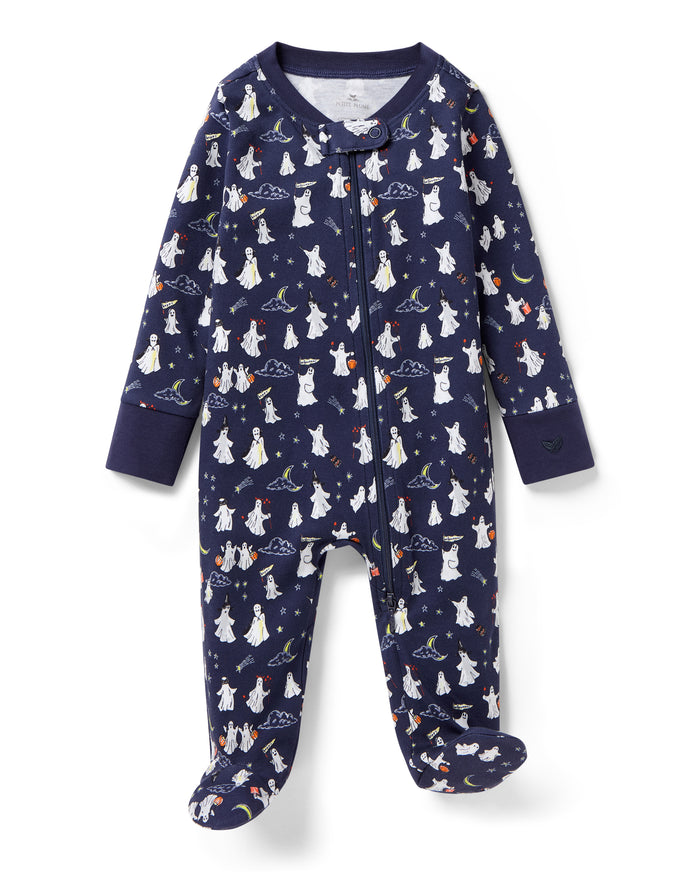 The Baby's Pima Romper in Spooky Slumber is a navy blue, long-sleeve, footed sleeper with a front zipper and features white polar bears in scarves and hats, stars, and geometric shapes on soft fabric.