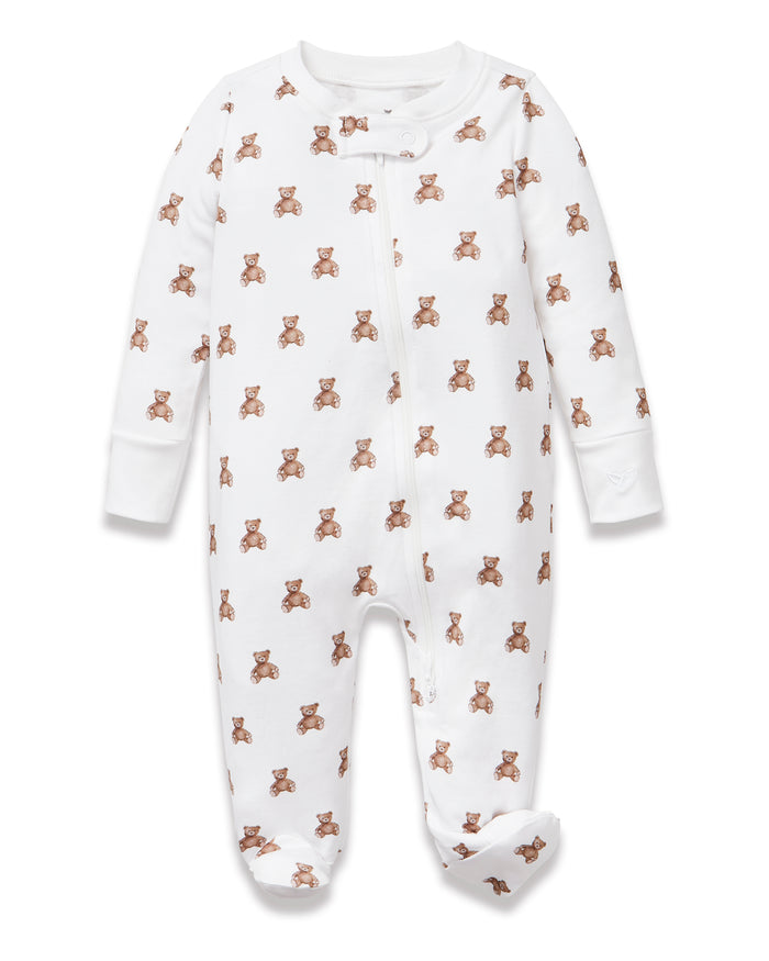 The Baby's Pima Romper in Teddy Tales features a white base with an all-over brown teddy bear print, long sleeves, a zip closure from neck to leg, and a snap button at the collar.