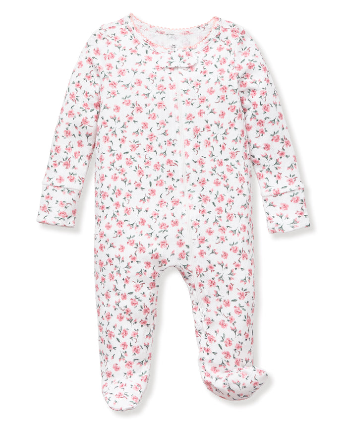Baby's Pointelle Footie Romper in Pink Floral features a white long-sleeve footed onesie with a pink and green floral print, shown flat on a white background.