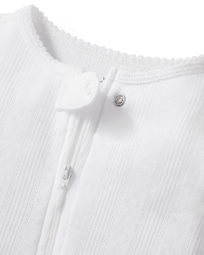 The Baby's Pointelle Footie Romper in White features long sleeves, covered feet, a front zipper, and a single neckline button, shown laid flat on a white background.