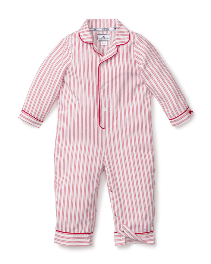 The Babys Twill Romper in Antique Red Ticking by Petite Plume is a childs long-sleeve jumpsuit with vertical red and white stripes, made from lightweight brushed twill. It features a collar, red trim on the cuffs and ankles, and a back flap pocket.