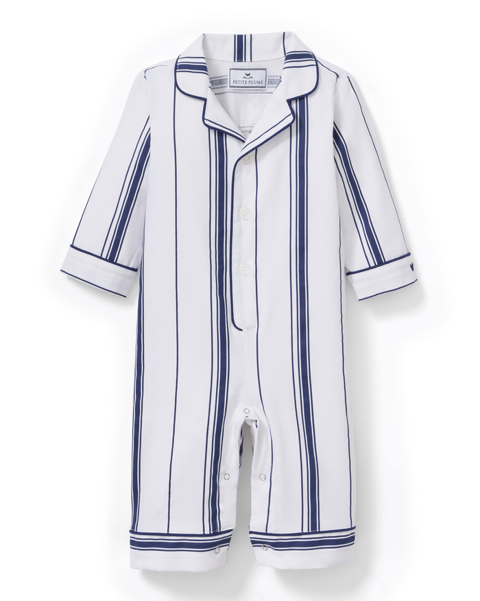 A white Baby’s Twill Classic Romper in Parlor Stripe, featuring long sleeves and legs with navy blue vertical stripes and buttons down the front.