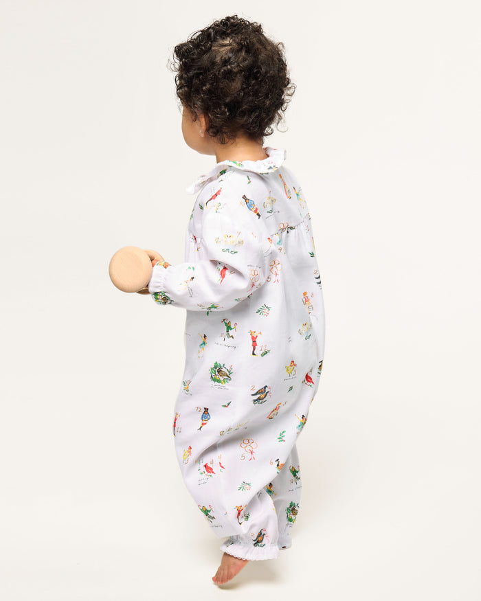 Baby's Twill Madeline Romper in 12 Days of Christmas: a white long-sleeve romper featuring colorful festive prints, a button-down front, and ruffled collar and cuffs.