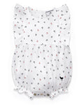 The Baby’s Twill Ruffled Romper in Anchors Away White features flutter sleeves and is adorned with charming navy blue and red anchor patterns. It includes elastic leg openings and snap buttons at the bottom for easy changing.