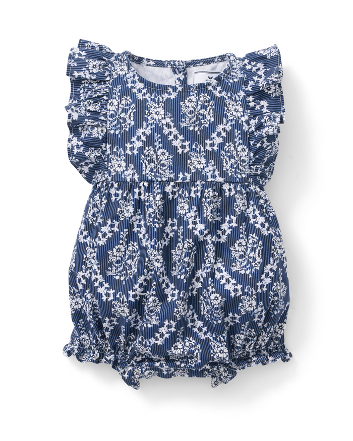 Baby’s Twill Ruffled Romper in Innkeeper Trellis features a blue and white patterned fabric with floral and geometric designs. This romper includes ruffled sleeves and leg openings, with gentle gathers at the waist and legs for a puffy, comfortable fit for your baby.