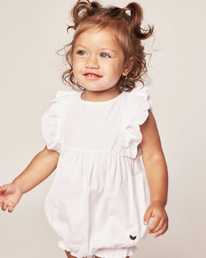White baby romper with ruffled sleeves on a white background