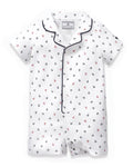 Baby’s Twill Summer Romper in Anchors Away White features short sleeves, a white base with navy and red anchor print, navy piping on the collar and trim, and convenient side snap buttons.