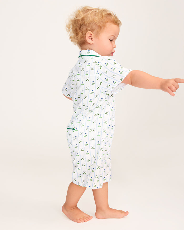 The Baby's Twill Summer Romper in Fairway Stripe is a short-sleeved, button-down romper with green piping, decorated with golf clubs and holes on white fabric with blue vertical stripes.