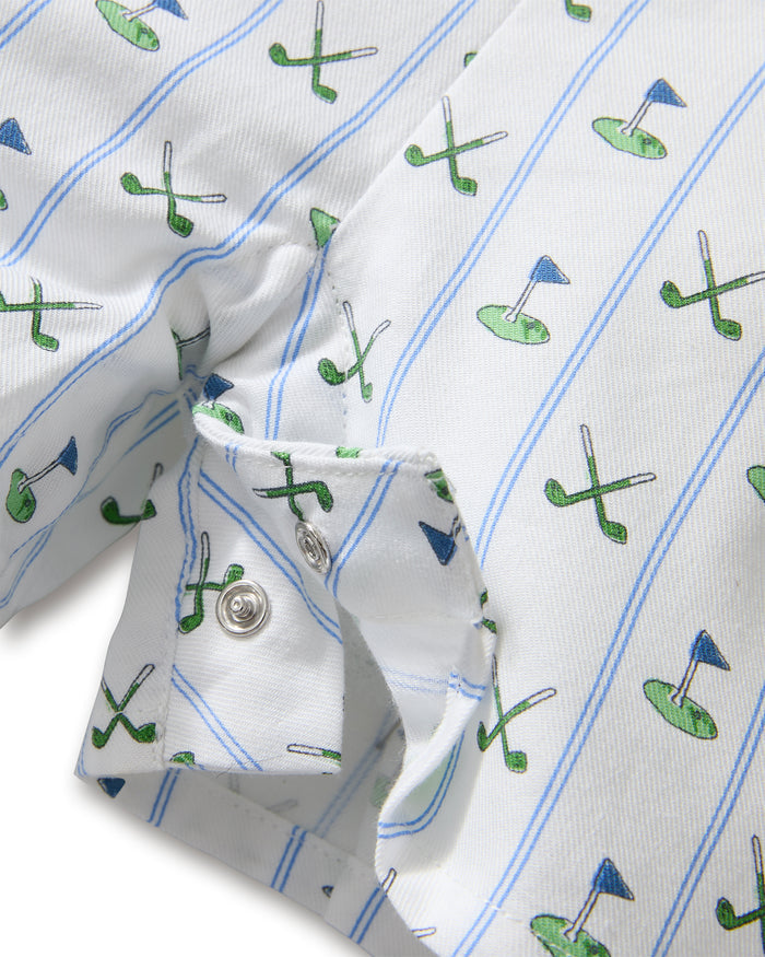 The Baby's Twill Summer Romper in Fairway Stripe is a short-sleeved, button-down romper with green piping, decorated with golf clubs and holes on white fabric with blue vertical stripes.
