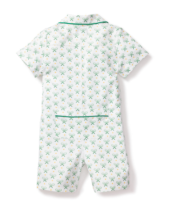 The back view of Petite Plumes Babys Twill Summer Romper in Match Point shows a white short-sleeved design with green trim, featuring a classic sport pattern of green tennis rackets and yellow balls, complete with a collar, chest pocket, and elastic waistband.