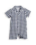 The Petit Plume Babys Twill Summer Romper in Navy Gingham is a short-sleeved, one-piece outfit with a navy and white checkered pattern, button-down front, white piping, and a small collar for an elegant look.