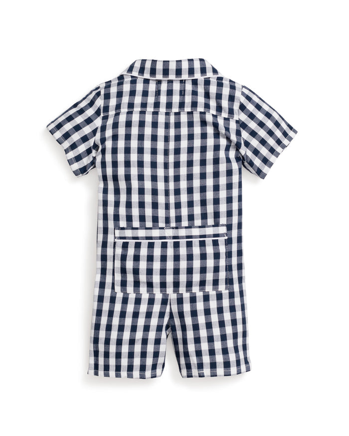 The back view of Petite Plumes Babys Twill Summer Romper shows a navy gingham print with a collared neckline, short sleeves, a back zipper closure, and waist pocket details.