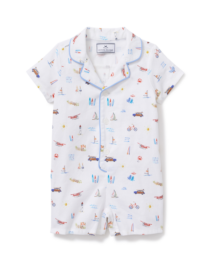 Baby’s Twill Summer Romper in Summer Nostalgia features short sleeves, crisp blue piping, and a cheerful beach-themed print with cars, sailboats, surfboards, bikes, and sandcastles. Designed with front buttons and a smart collar for easy dressing.