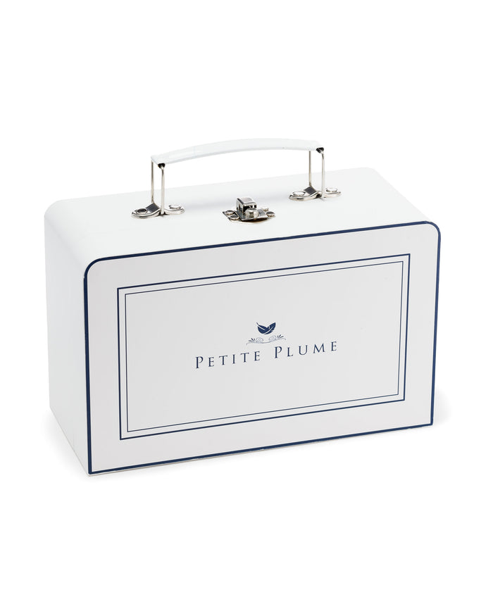 A white rectangular box with a handle and navy blue trim features Petite Plume and a feather logo, ideal for gifting the luxurious Cashmere Baby Blanket in Ivory.