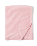 A soft, cashmere baby blanket in rose from Petite Plume is neatly folded against a white background, featuring a simple border detail. Handmade in Nepal, it makes the perfect luxury baby gift.