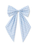 A floral wreath of small white and pink blooms hangs on a beige door, adorned with the Easter Basket and Wreath Bow in Light Blue Gingham featuring long ribbon tails.