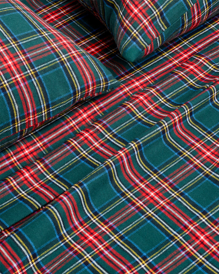 The Flannel Bed Sheet Set in Kensington Tartan features a neatly folded green, red, and white checkered plaid design, displayed against a white background.