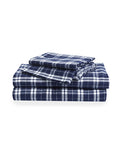 The Flannel Bed Sheet Set in Oxford Tartan features neatly folded navy blue and white plaid sheets with matching pillowcases, displayed on a white background.