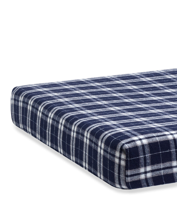 A close-up of the Flannel Crib Sheet in Oxford Tartan, showcasing its navy blue and white plaid fabric with evenly spaced vertical and horizontal stripes in a classic checkered design.