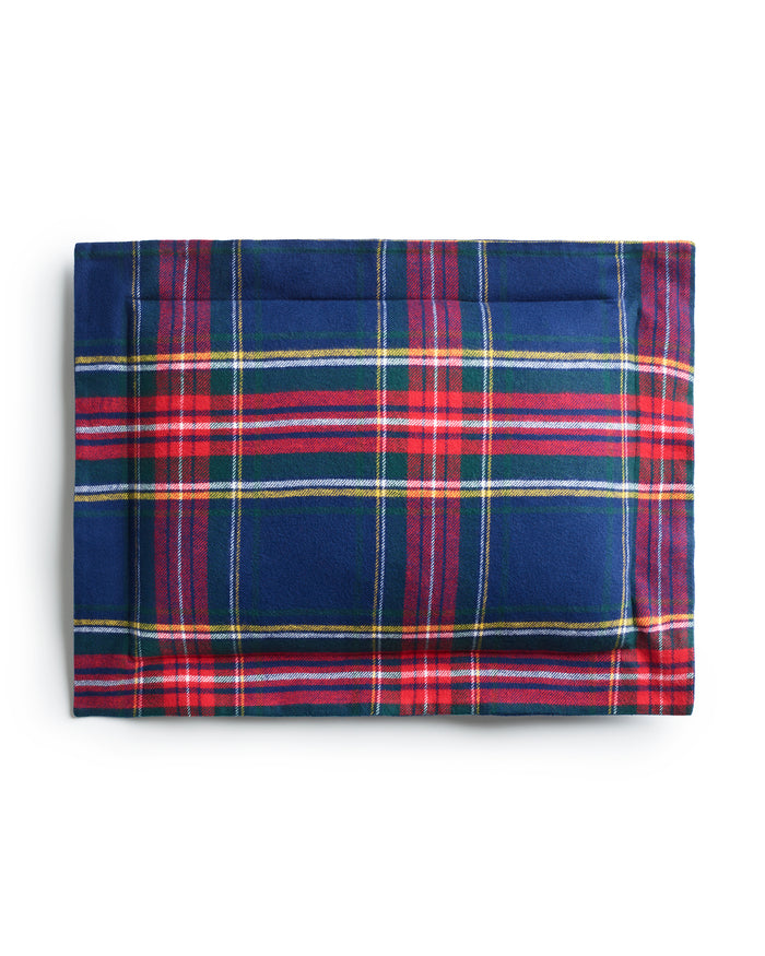A folded Flannel Decorative Pillow in Windsor Tartan by Petite Plume, featuring a blue base with red, green, and white plaid pattern, crafted from brushed cotton flannel. It is neatly displayed against a plain white background.