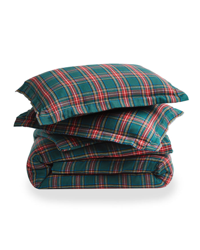 The Flannel Duvet Set in Kensington Tartan features a green, red, and white plaid pattern and includes a comforter and two pillows, all neatly folded against a white background.