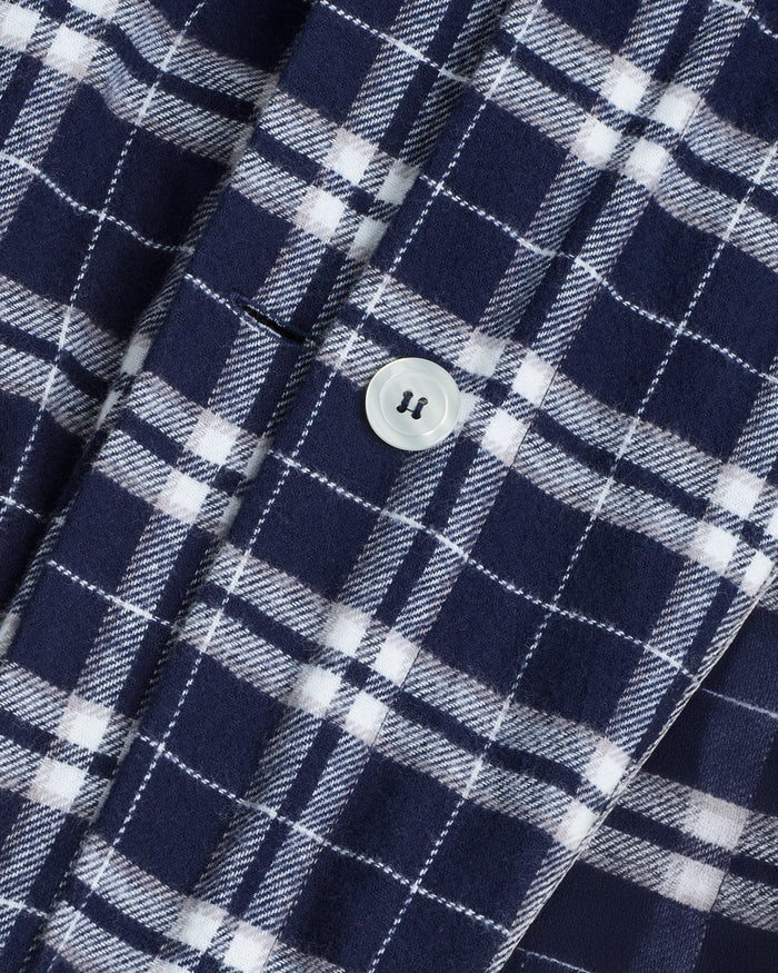 The Flannel Duvet Set in Oxford Tartan features a neatly folded blue and white plaid comforter with two matching pillowcases stacked on top, displayed against a plain white background.