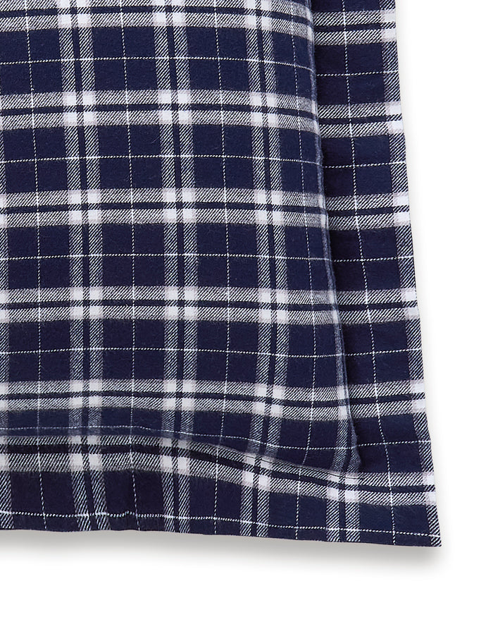 The Flannel Euro Sham in Oxford Tartan features a rectangular shape and a navy blue and white plaid checkerboard pattern set against a crisp white background.