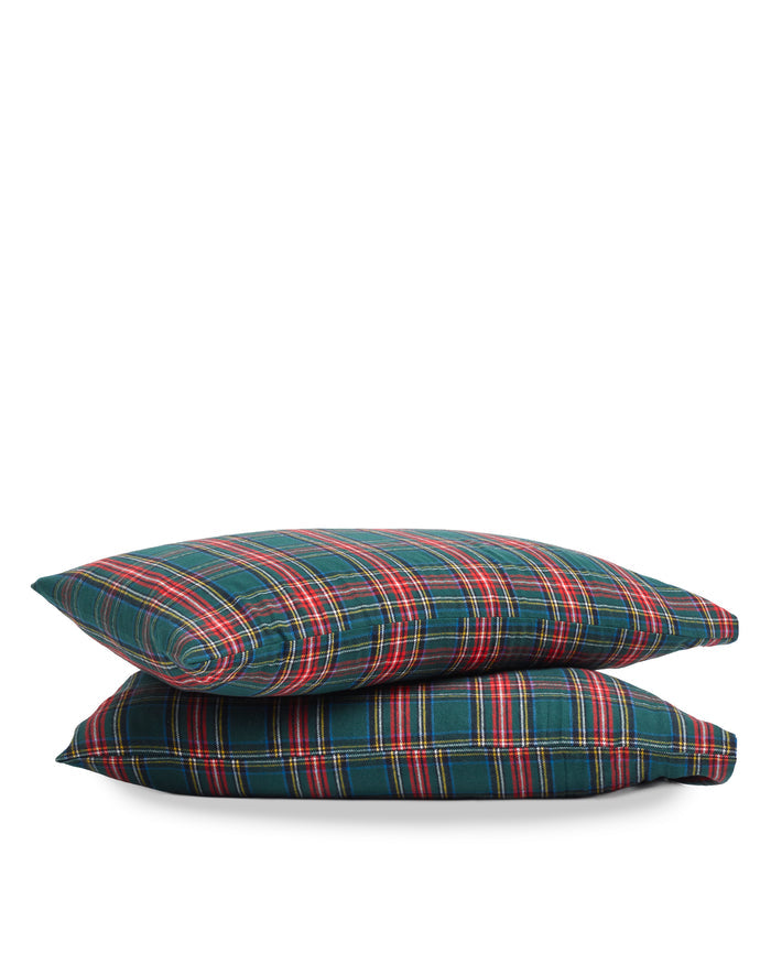 Two Flannel Pillow Cases in Kensington Tartan, featuring a green, red, and yellow plaid pattern, are stacked against a white background.