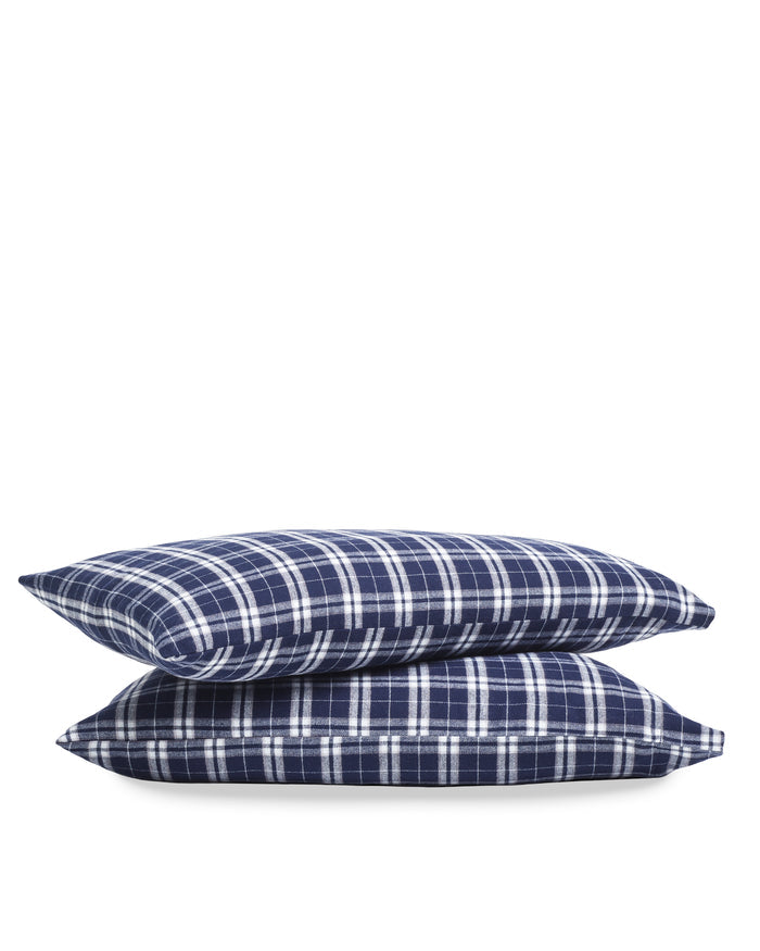 Two Flannel Pillow Cases in Oxford Tartan, each with a navy blue and white plaid pattern, are stacked on top of each other against a plain white background.